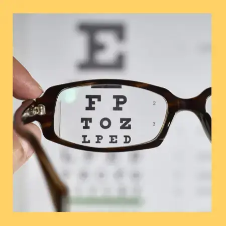Looking through glasses to an eye chart